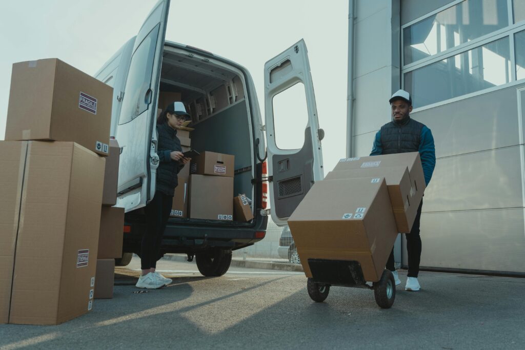 pexels photo 6169668 6169668 Two couriers load boxes into a van for shipment, showcasing logistics and teamwork.