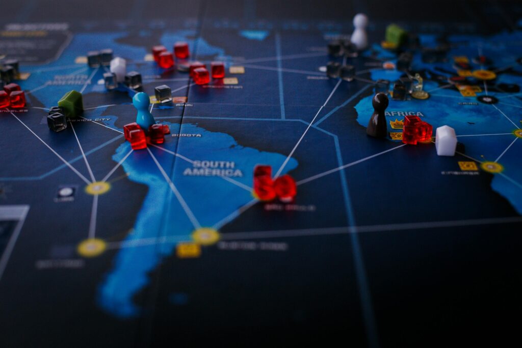 pexels photo 8159115 8159115 1 A strategic board game featuring a world map and colorful playing pieces.